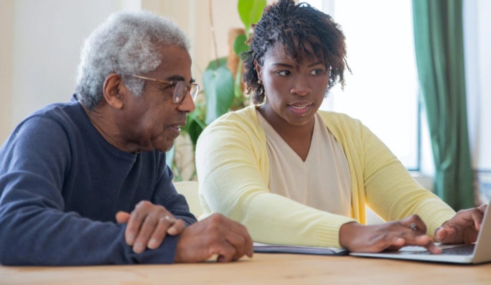 Two people using the computer